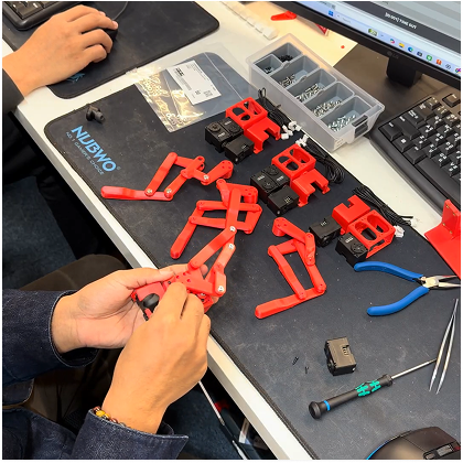 Hand-assembling robotic hardware components